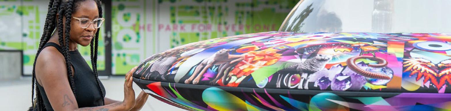 image of a young blac woman looking at a flying saucer