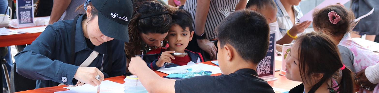 A group of kids work together on an art project. 