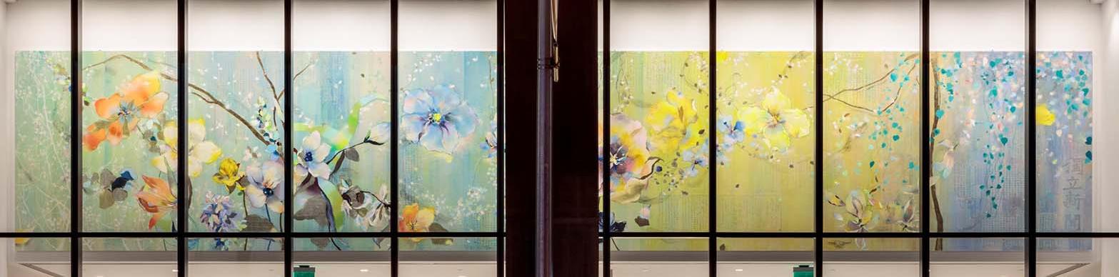 two large canvasses of flower art on a wall