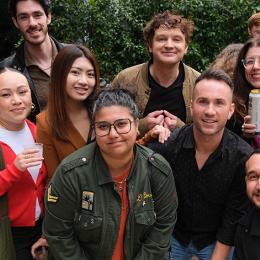 A group of multi-cultural individual pose from a group photo