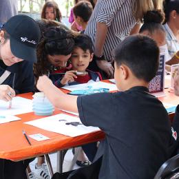 A group of kids work together on an art project. 